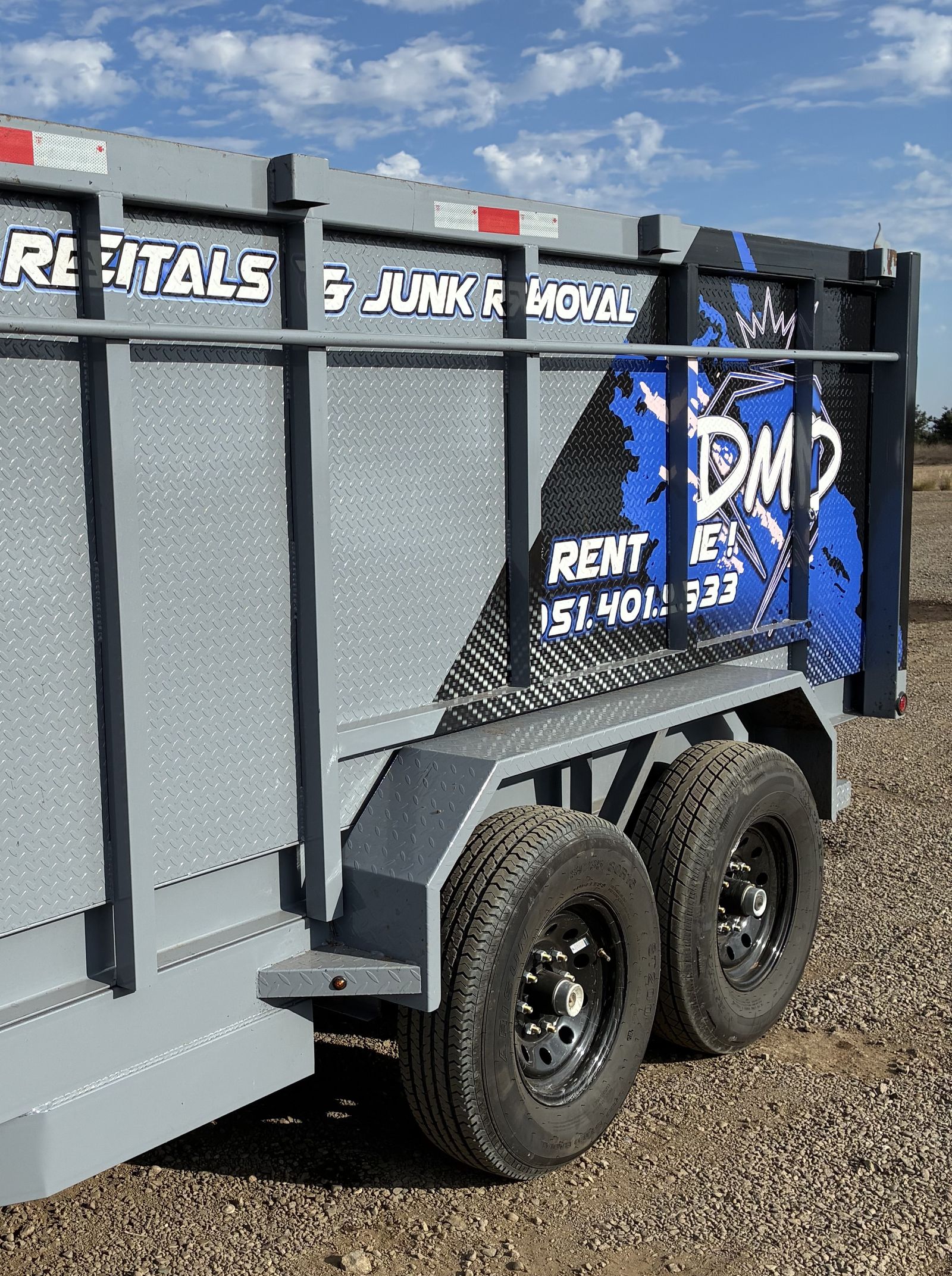 DMD Junk Removal 14-foot dump trailer, driveway-friendly rubber tires